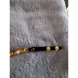 Black & Gold chain bracelet with faux leather and snap. Fit up to size 7.34